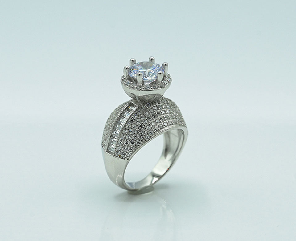 This exquisite Silver 925 ladies' ring is rhodium-plated for a brilliant finish, featuring a stunning spinel ruby at the center, accented with sparkling zircons, adding a touch of elegance and luxury to any collection.